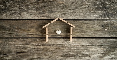 Real estate concept with a heart inside the frame of a house